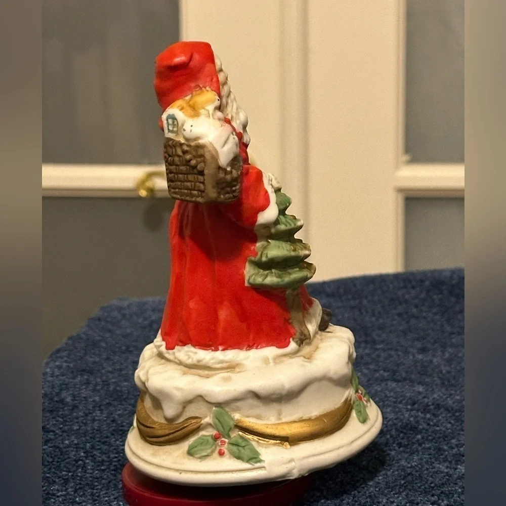 Revolving porcelain Santa musical figure plays Santa Claus is Coming to Town.